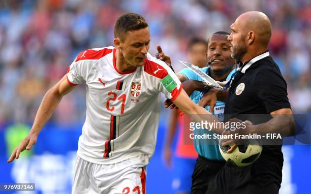 Nemanja Matic of Serbia tries to get the ball from Costa Rica coach Luis Marin as fourth official tries to step in during the 2018 FIFA World Cup...