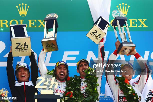 The Toyota Gazoo Racing TS050 Hybrid team of Fernando Alonso, Sebastien Buemi and Kazuki Nakajima celebrate alongside Shigeki Tomoyama of Toyota...