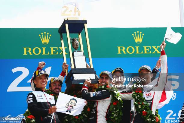 The Toyota Gazoo Racing TS050 Hybrid team of Fernando Alonso, Sebastien Buemi and Kazuki Nakajima celebrate alongside Shigeki Tomoyama and Hisatake...