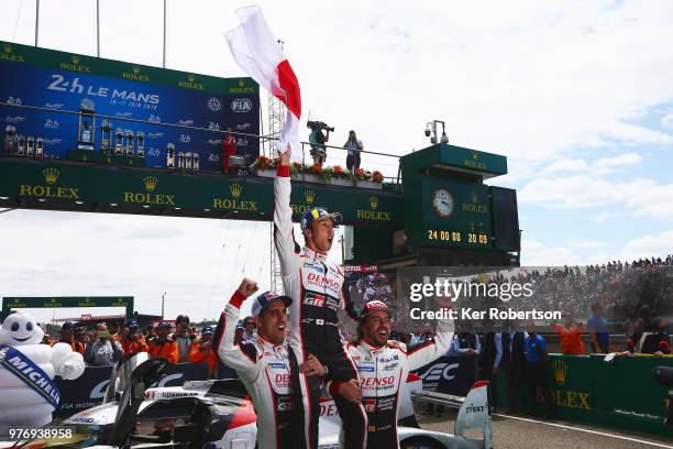 The Toyota Gazoo Racing TS050 Hybrid team of Sebastien Buemi, Kazuki Nakajima and Fernando Alonso celebrate after Toyota win for the first time at...