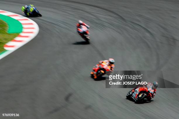 Ducati Team's Spanish rider Jorge Lorenzo rides ahead of Repsol Honda Team's Spanish rider Marc Marquez during the Catalunya MotoGP Grand Prix race...