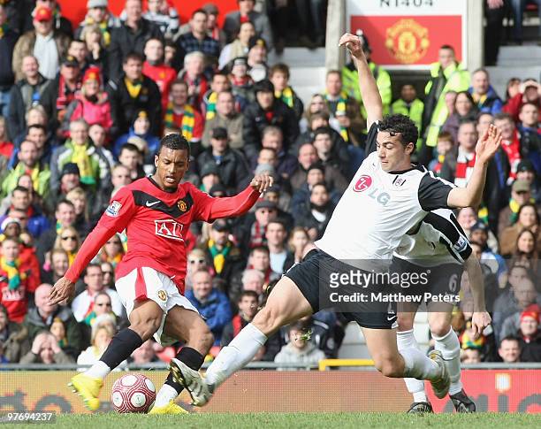 Nani of Manchester United clashes with Stephen Kelly of Fulham during the FA Barclays Premier League match between Manchester United and Fulham at...