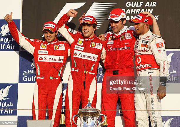 Race winner Fernando Alonso of Spain and Ferrari is seen alongside third placed Lewis Hamilton of Great Britain and McLaren Mercedes, second placed...