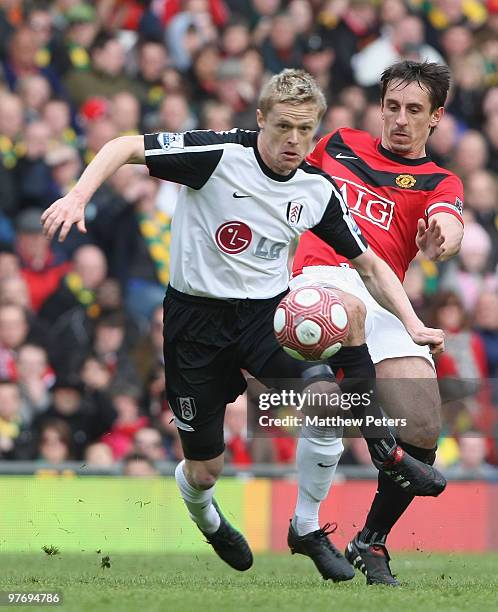 Gary Neville of Manchester United clashes with Damien Duff of Fulham during the FA Barclays Premier League match between Manchester United and Fulham...