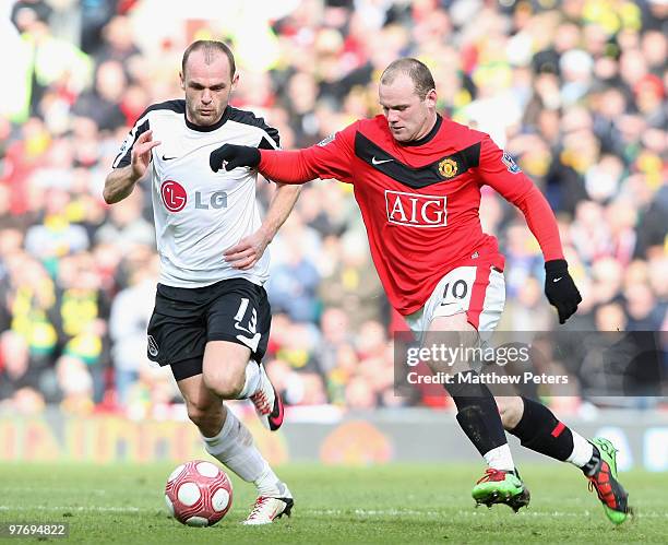 Wayne Rooney of Manchester United clashes with Danny Murphy of Fulham during the FA Barclays Premier League match between Manchester United and...