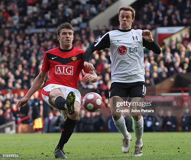 Michael Carrick of Manchester United clashes with Erik Nevland of Fulham during the FA Barclays Premier League match between Manchester United and...