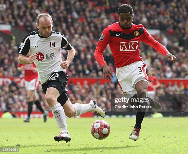 Patrice Evra of Manchester United clashes with Danny Murphy of Fulham during the FA Barclays Premier League match between Manchester United and...