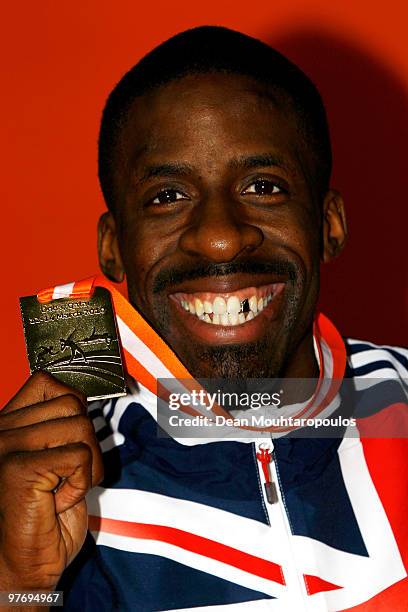 Dwain Chambers of Great Britain holds his gold medal for the mens 60m during Day 3 of the IAAF World Indoor Championships at the Aspire Dome on March...