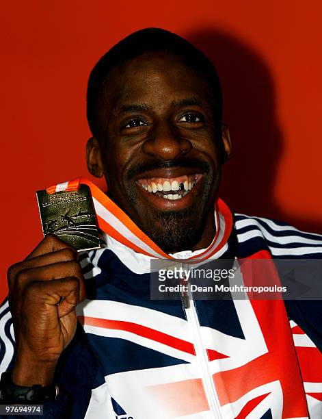 Dwain Chambers of Great Britain holds his gold medal for the mens 60m during Day 3 of the IAAF World Indoor Championships at the Aspire Dome on March...