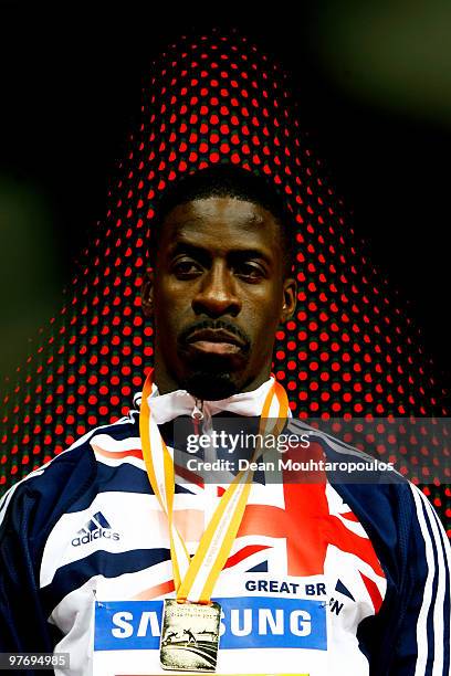 Dwain Chambers of Great Britain poses with his gold medal for the mens 60m during Day 3 of the IAAF World Indoor Championships at the Aspire Dome on...