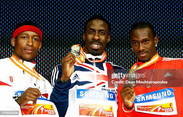 Mike Rodgers of United States celebrates the silver medal, Dwain Chambers of Great Britain the gold medal and Daniel Bailey of Antigua And Barbuda...