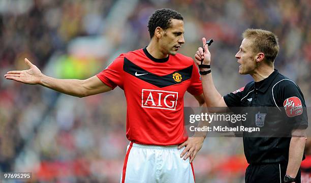 Rio Ferdinand of Manchester United talks to referee Michael Jones during the Barclays Premier League match between Manchester United and Fulham at...