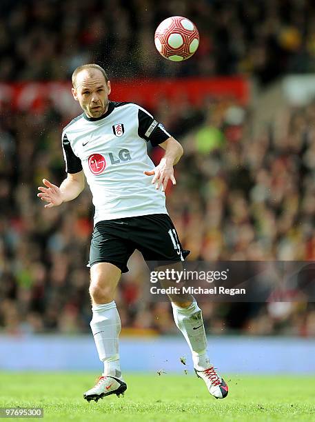 Danny Murphy of Fulham heads the ball during the Barclays Premier League match between Manchester United and Fulham at Old Trafford on March 14, 2010...
