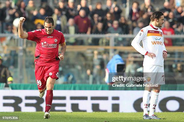 Cristiano Lucarelli of AS Livorno Calcio celebrates the goal and Marco Cassetti show his dejection during the Serie A match between AS Livorno Calcio...