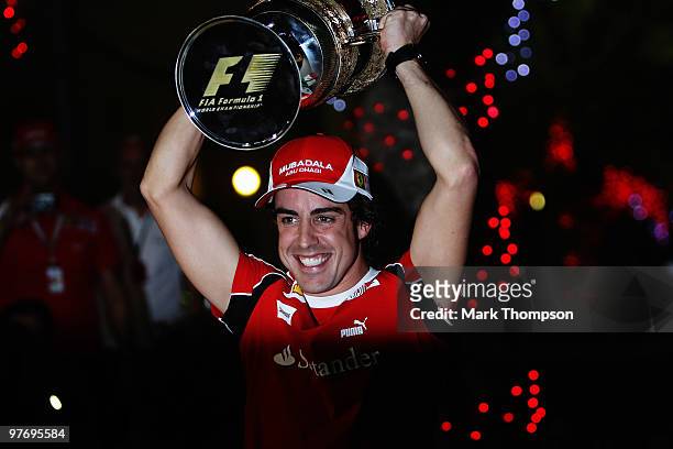 Fernando Alonso of Spain and Ferrari celebrates in the paddock with team mates after winning the Bahrain Formula One Grand Prix at the Bahrain...