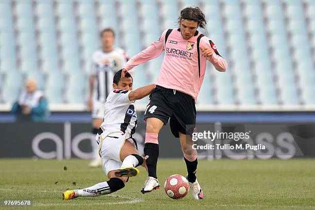 Nicolas Bertolo of Palermo and Alexis Sanchez of Udinese compete for the ball during the Serie A match between Udinese Calcio and US Citta di Palermo...