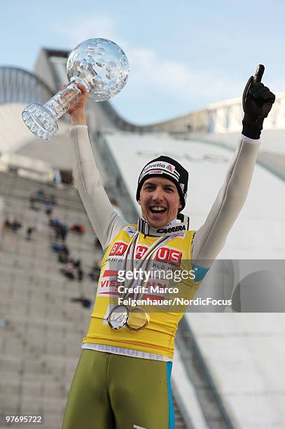 Simon Ammann of Switzerland holds up the Overall World Cup Bowl after the Ski Jumping HS 134 event in the FIS Ski Jumping World Cup on March 14, 2010...