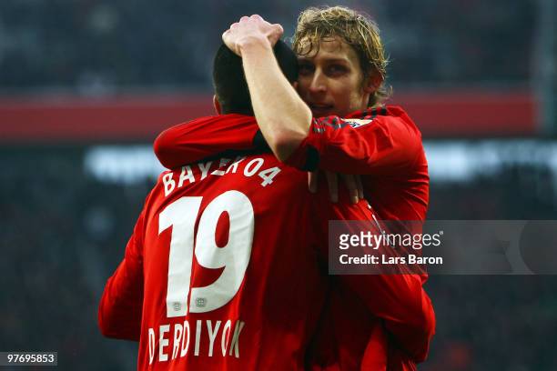 Stefan Kiessling of Leverkusen celebrates with team mate Eren Derdiyok after scoring his teams first goal during the Bundesliga match between Bayer...