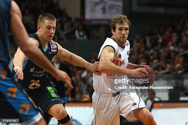 Zack Whiting of Duesseldorf drives to the basket against John Goldsberry of Bamberg during the Basketball Bundesliga match between Brose Baskets...