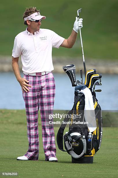 Ian Poulter of England pulls a club from his bag on the 18th hole during the final round of the 2010 WGC-CA Championship at the TPC Blue Monster at...