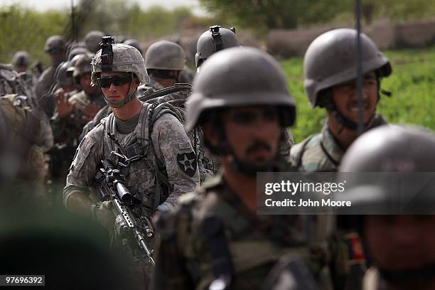 And Afghan Army soldiers depart after a firefight with Taliban insurgents on March 14, 2010 at Howz-e-Madad in Kandahar province, Afghanistan. Attack...