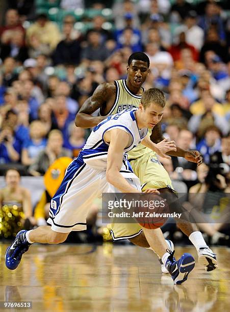 Jon Scheyer of the Duke Blue Devils is chased by Iman Shumpert of the Georgia Tech Yellow Jackets in the championship game of the 2010 ACC Men's...