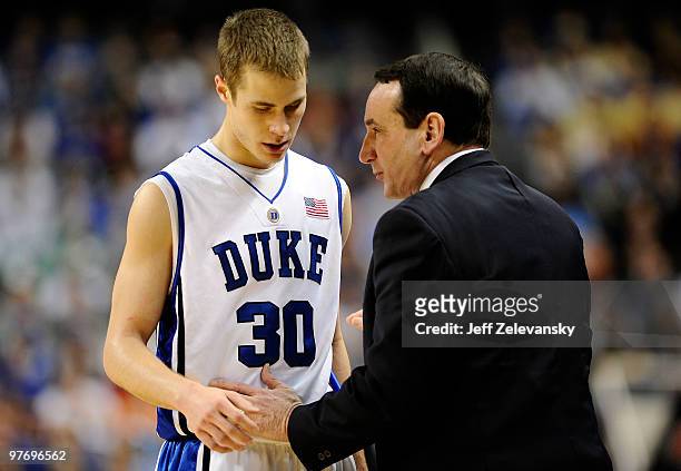 Jon Scheyer and Mike Krzyzewski head coach of the Duke Blue Devils confer against the Georgia Tech Yellow Jackets in the championship game of the...