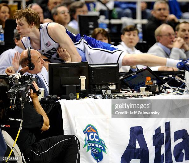 Kyle Singler of the Duke Blue Devils jumps into ESPN commentator Dick Vitale during game against the Georgia Tech Yellow Jackets in the championship...