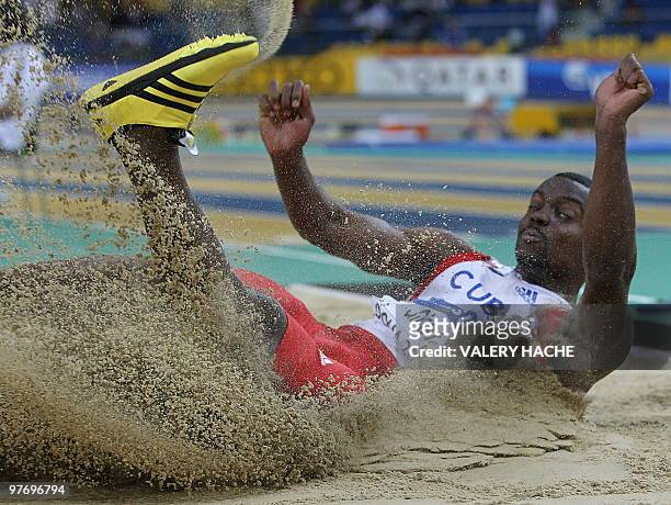 Cuba's Arnie David Girat competes in the men's triple jump final at the 2010 IAAF World Indoor Athletics Championships at the Aspire Dome in the...