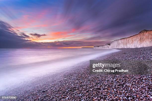 birling gap gravel beach at sunset, eastbourne, england, uk - birling gap stock pictures, royalty-free photos & images