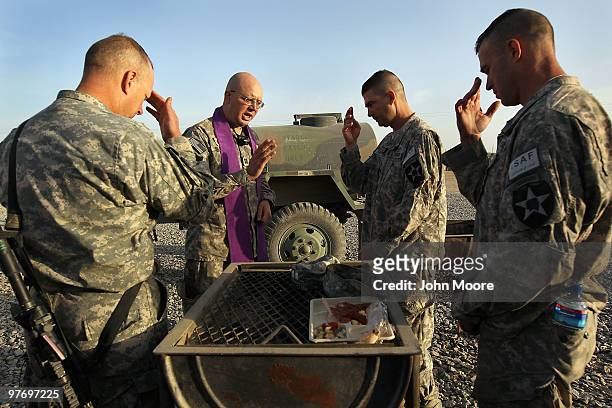 Catholic Chaplain Cpt. Carl Subler blesses U.S. Army commanders before a military operation on March 14, 2010 at Howz-e-Madad in Kandahar province,...