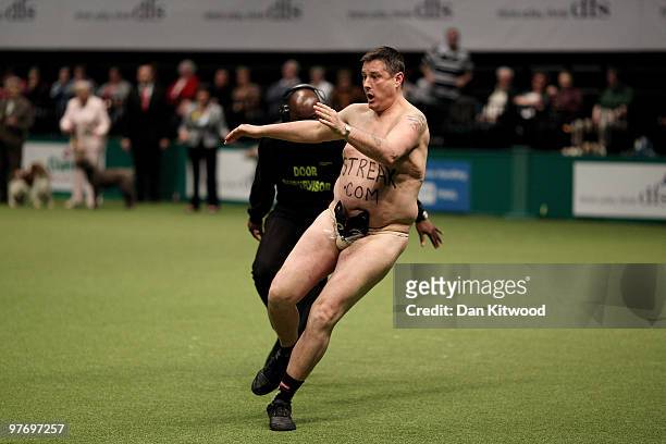 Man streaks accross the floor of the main arena on the fourth and final day of the annual Crufts dog show at the National Exhibition Centre on March...