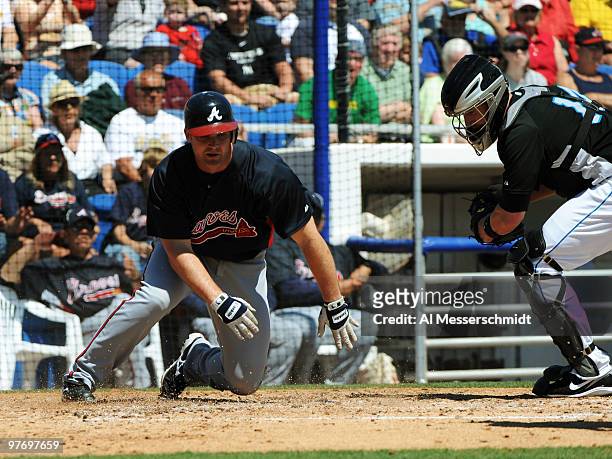 Catcher David Ross of the Atlanta Braves slides into home for a run against the Toronto Blue Jays March 14, 2010 at the Dunedin Stadium in Dunedin,...