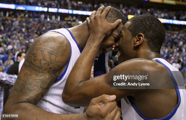 DeMarcus Cousins and John Wall of the Kentucky Wildcats celebrate after they won 75-74 in overtime against the Mississippi State Bulldogs during the...