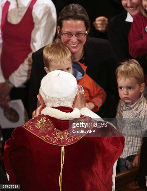 Pope Benedict XVI greets children during his visit to Rome's Lutheran church on March 14, 2010. The Vatican fought attempts to link Pope Benedict XVI...