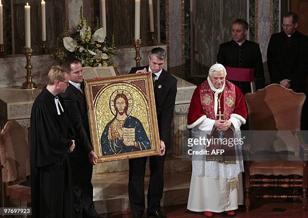 Lutheran Jens-Martin Kruse is presented with a gift by Pope Benedict XVI on the occasion of Pontiff's visit to Rome's Lutheran church, on March 14,...