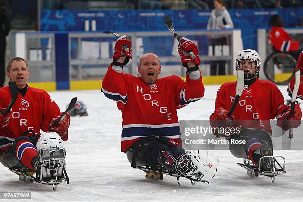 Stig Tore Svee, Kjell Vidar Royne and Loyd Remi Johansen of Italy celebrate their 2-1 victory over Italy during the Ice Sledge Hockey Preliminary...