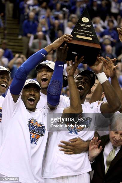 John Wall, DeMarcus Cousins and Patrick Patterson of the Kentucky Wildcats celebrate with the trophy along with his teammates after they won 75-74 in...