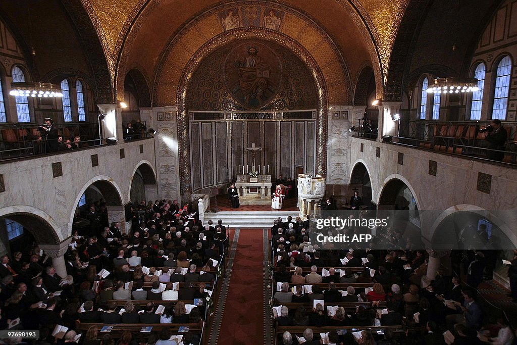 Pope Benedict XVI (R background) during