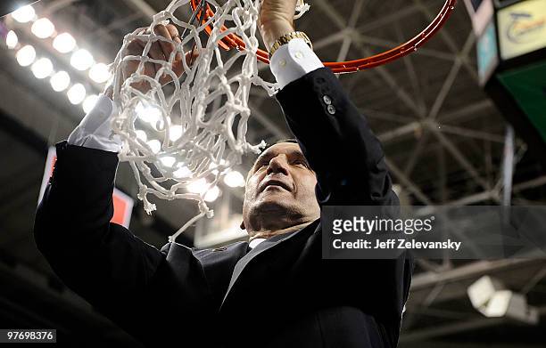 Mike Krzyzewski head coach of the Duke Blue Devils cuts down the net after win over the Georgia Tech Yellow Jackets in the championship game of the...