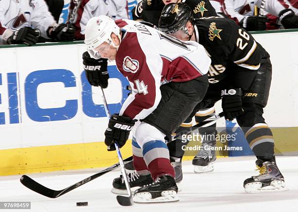John-Michael Liles of the Colorado Avalanche tries to keep the puck away against Jere Lehtinen of the Dallas Stars on March 14, 2010 at the American...