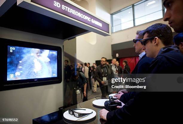 Attendees play a Sony PlayStation video game wearing 3-D glasses at the 2010 Game Developers Conference in San Francisco, California, U.S., on...