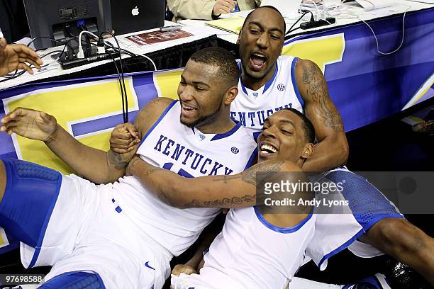 DeMarcus Cousins, Ramon Harris and Darnell Dodson of the Kentucky Wildcats celebrate after Cousins made a 2-point basket at the end of regulation to...