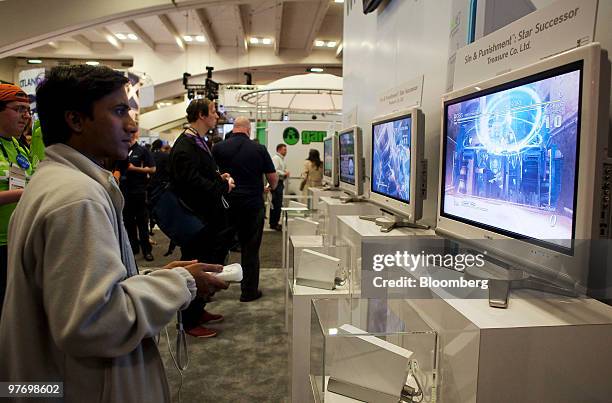 An attendee at the 2010 Game Developers Conference plays a Nintendo Wii video game in San Francisco, California, U.S., on Thursday, March 11, 2010....