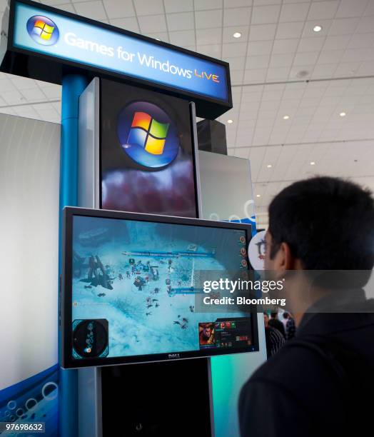 An attendee watches a game for Microsoft Windows at the 2010 Game Developers Conference in San Francisco, California, U.S., on Thursday, March 11,...