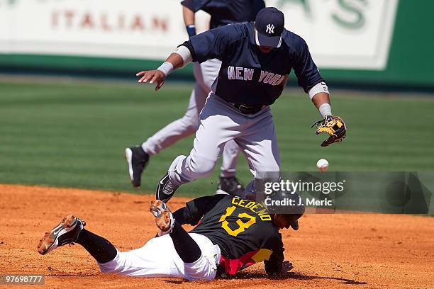 Infielder Ronny Cedeno of the Pittsburgh Pirates steals second base as infielder Robinson Cano of the New York Yankees tries to get out of the way...