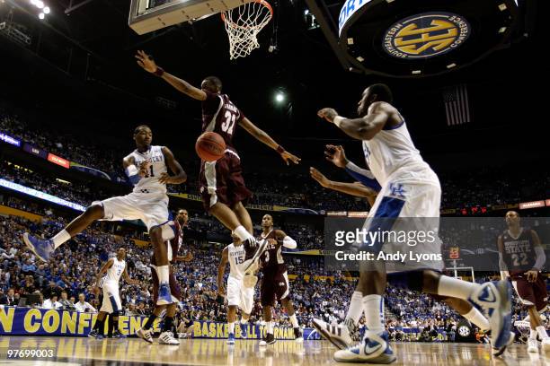 John Wall of the Kentucky Wildcats passes the ball to Patrick Paterson against Jarvis Varnado of the Mississippi State Bulldogs during the final of...