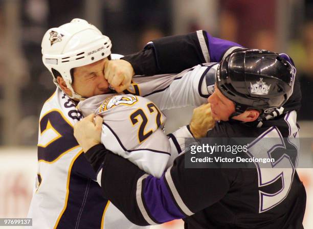 Richard Clune of Los Angeles Kings punches Jordin Tootoo of the Nashville Predators during their fight in the second period of their NHL game at the...