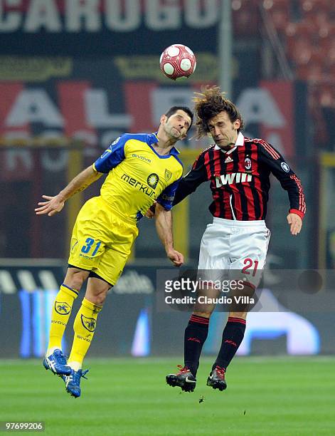 Andrea Pirlo of AC Milan competes for the ball with Sergio Pellissier of AC Chievo during the Serie A match between AC Milan and AC Chievo Verona at...