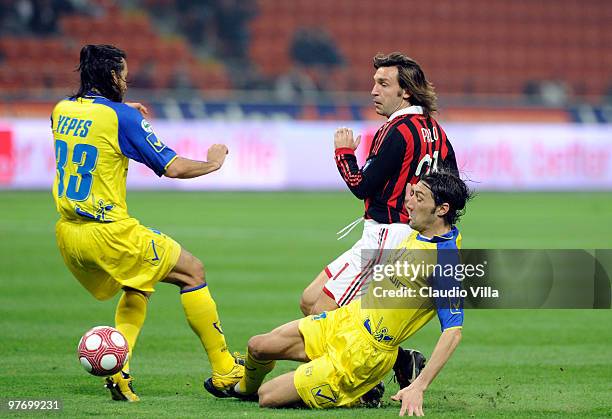 Andrea Pirlo of AC Milan competes for the ball with Davide Mandelli of AC Chievo during the Serie A match between AC Milan and AC Chievo Verona at...